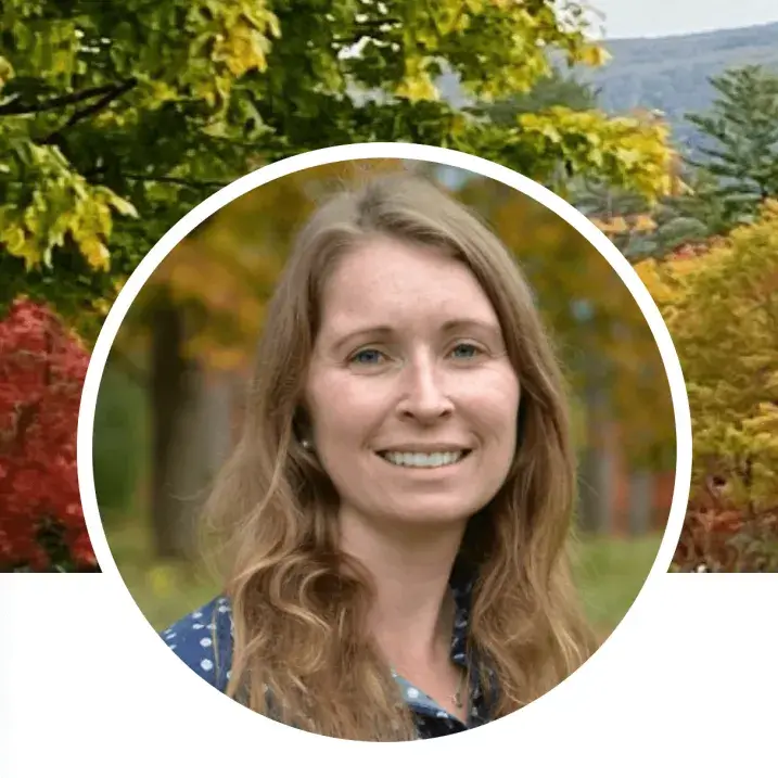 Woman in front of fall foliage