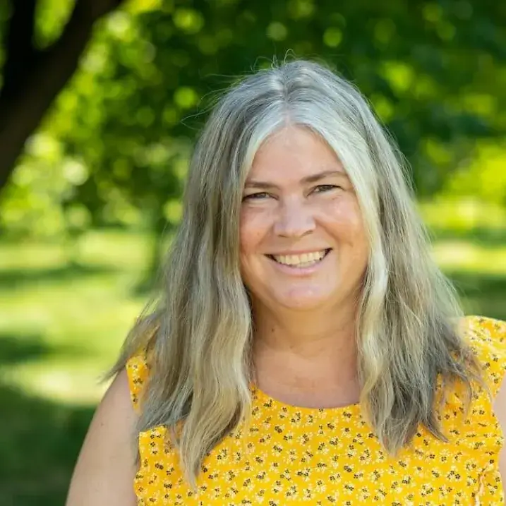 Woman with green grass behind
