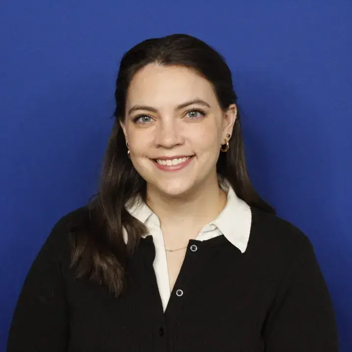 Headshot of Megan - blue backdrop