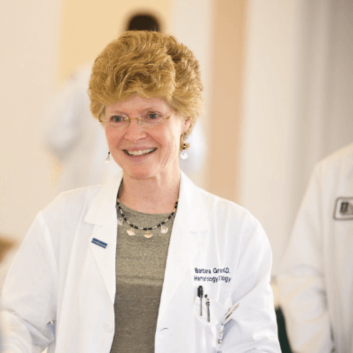 A person wearing a white coat