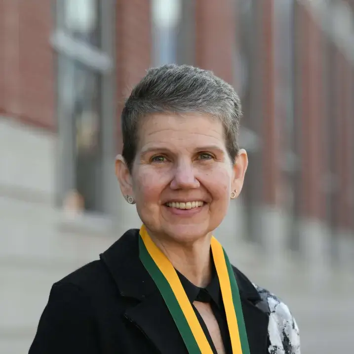 Portrait of Margaret A. Vizzard standing in front of Larner College of Medicine