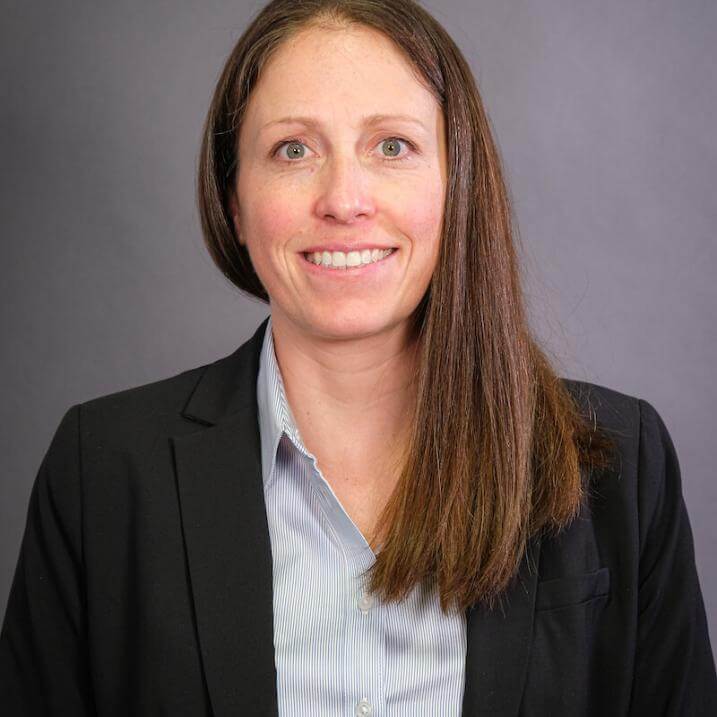 A person wearing  a blue shirt and a black blazer