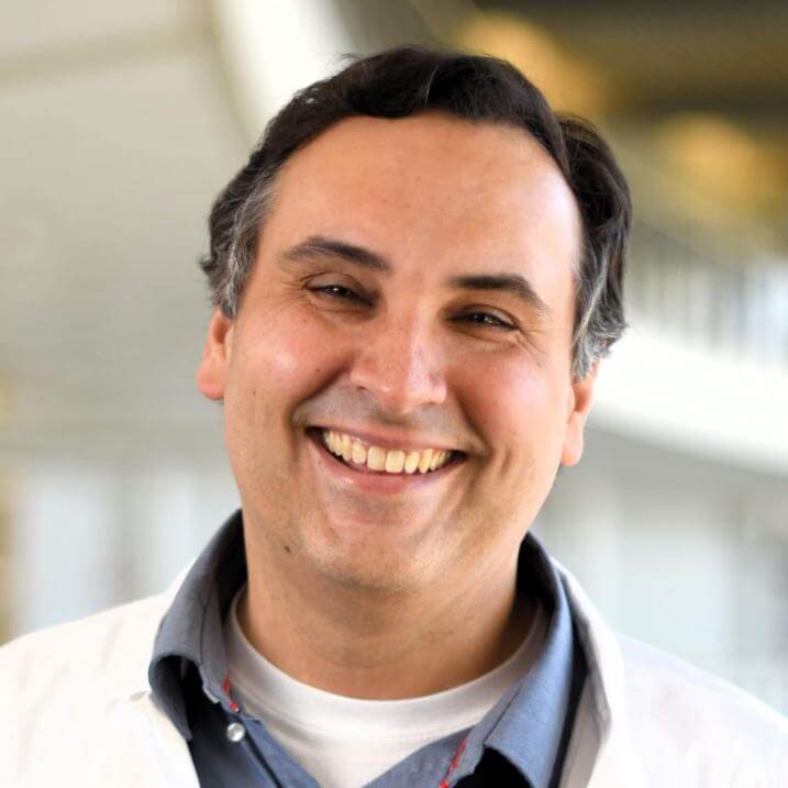 A person wearing a blue collared shirt