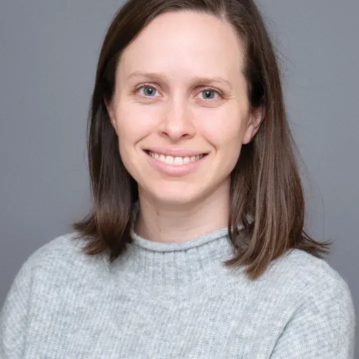A person wearing a gray sweater