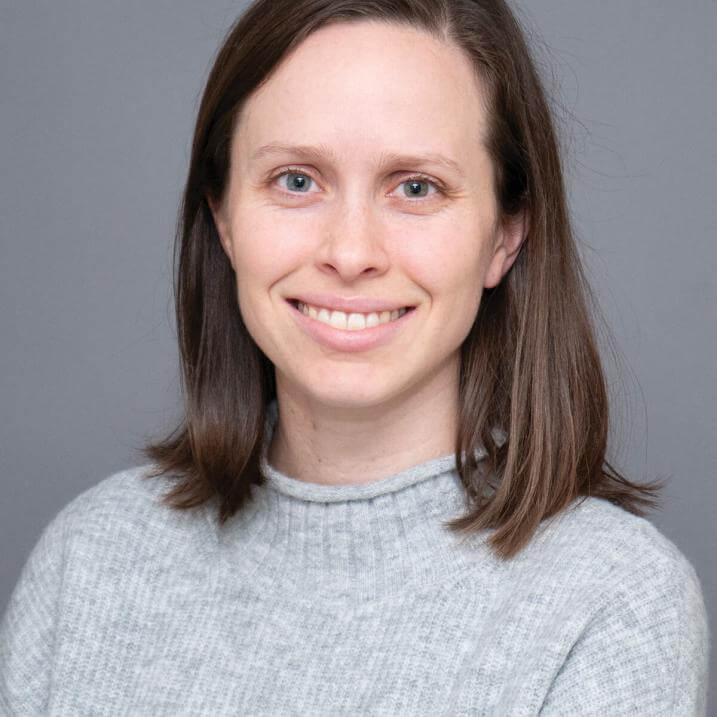 A person wearing a gray sweater