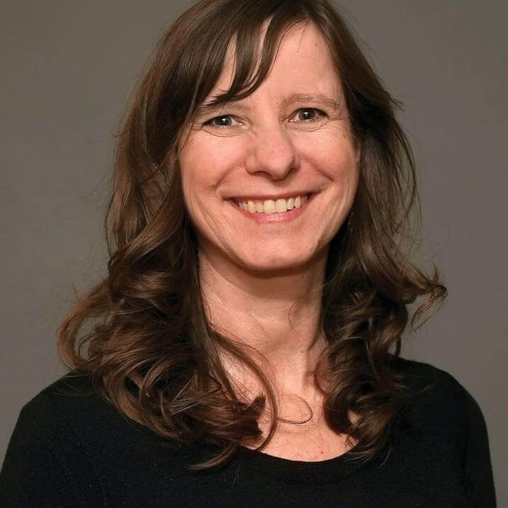 A person with brown hair wearing a black shirt