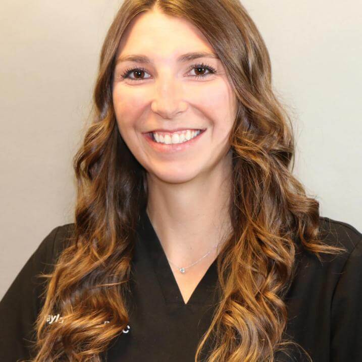 A person with brown hair wearing a black shirt