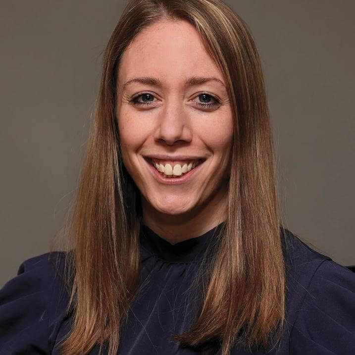 A person with long hair wearing a blouse