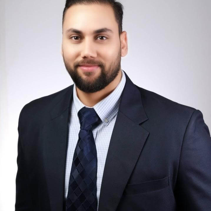 A person wearing a blazer and tie