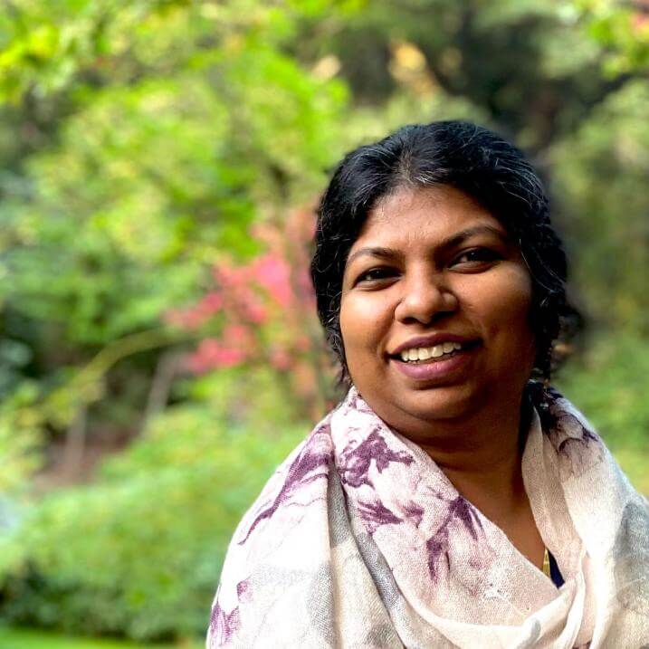 Headshot of Srivi in front of garden