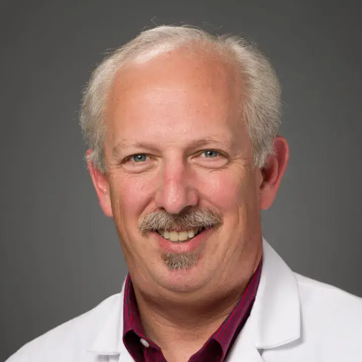 headshot of man in doctors coat