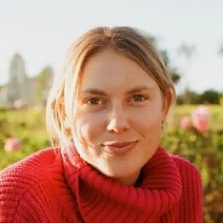 Darian in front of a flower garden
