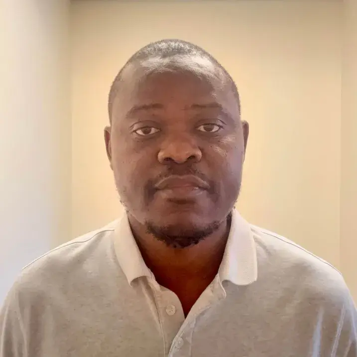 A person wearing a white polo shirt