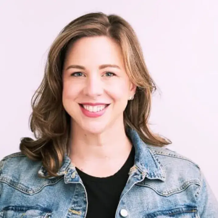 A woman with brown hair smiles at the camera.