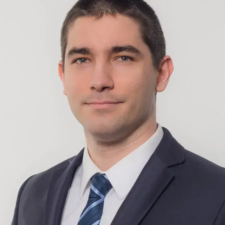 A person wearing a blazer and a tie