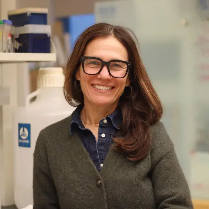 Nicole smiling in a lab