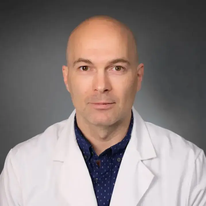 Jeremy Barry in white coat with blue shirt