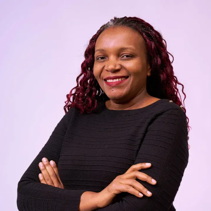 A woman with a dark dress against a purple background