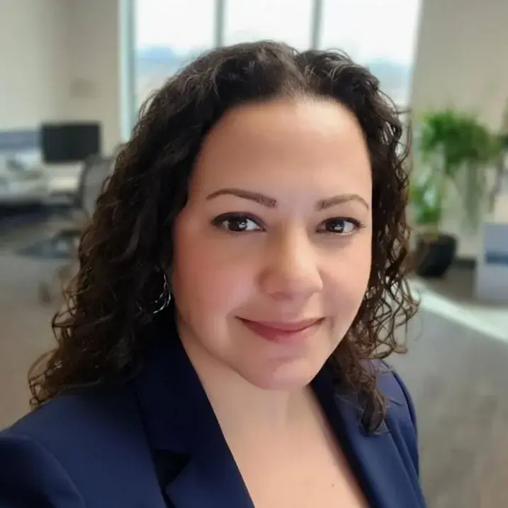 Jaydeen wearing a blue blazer and looking forward to the camera smiling