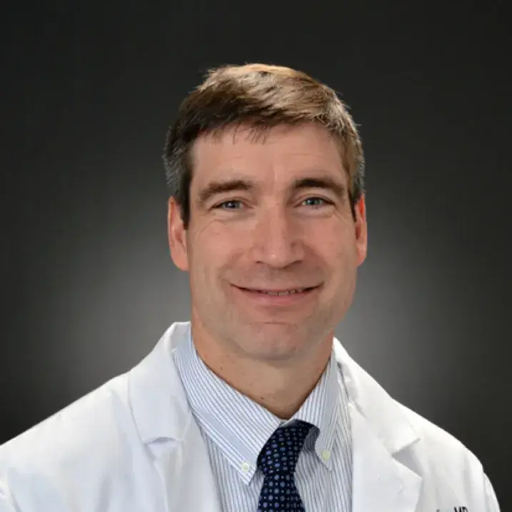 man smiling in white coat