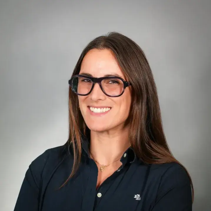 portrait of person wearing dark heavy rimmed glasses, long hair and a black shirt