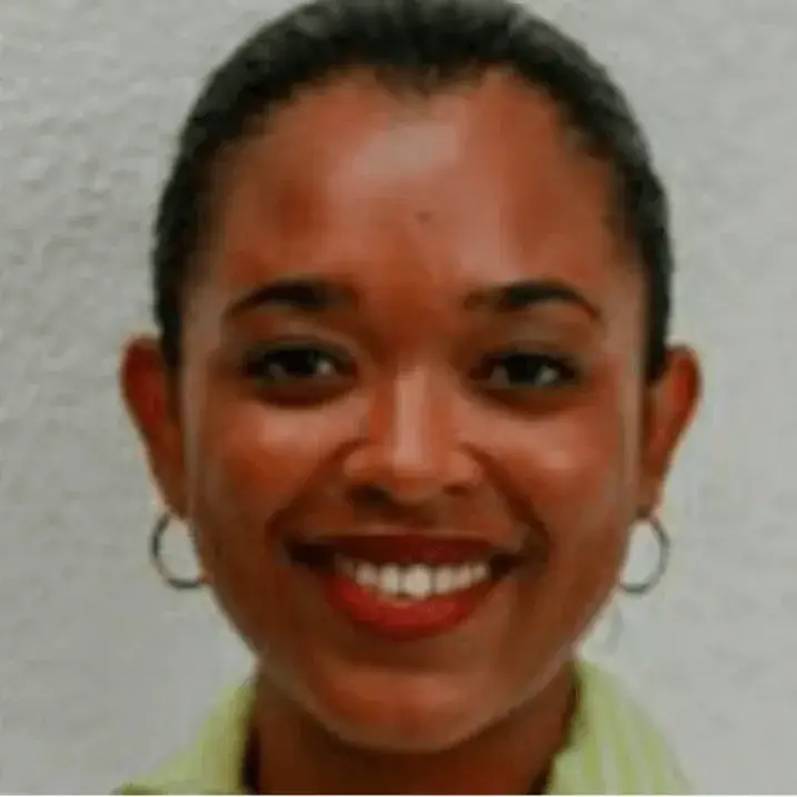 A person wearing earrings and a collared shirt