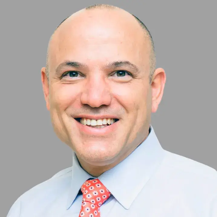 man in light blue dress shirt and red decorated tie