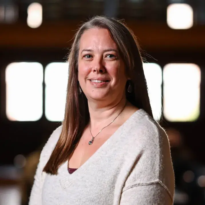 Professional portrait of Tiffany Sharp with a blurred indoor background