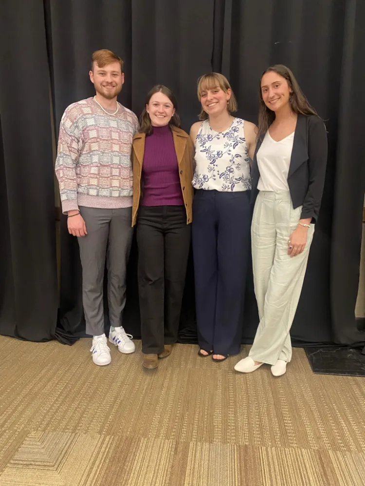 4 college students on a stage