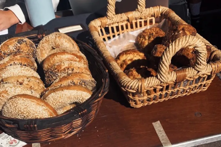 baskets of bagels and scones on a wooden table