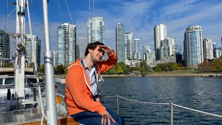 Aidan Seipke '22 sitting on boat in Boston Harbor