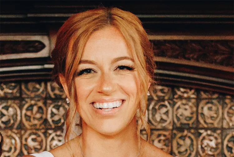 Smiling person with pinned up hair indoor setting