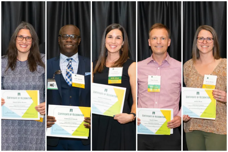 Educators holding their award cerficates