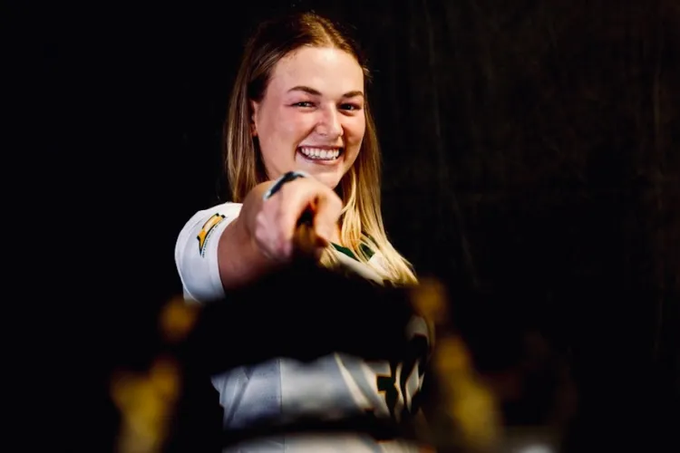 Taylor Mullen in her UVM women's lacrosse uniform holding her lacrosse stick