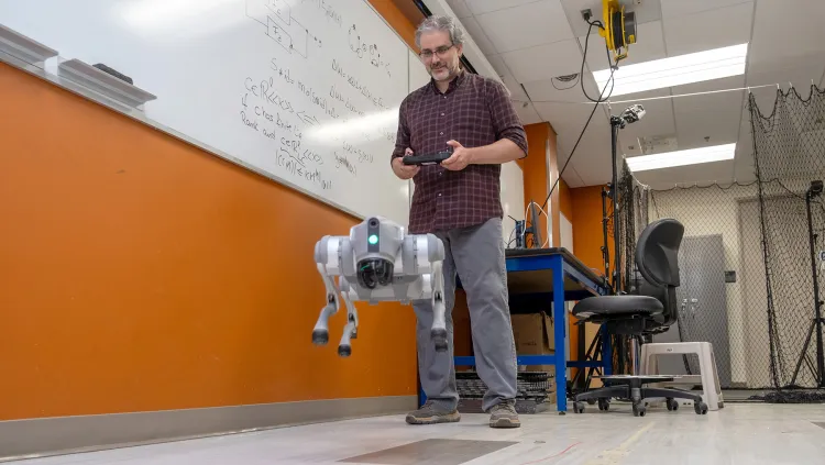 Luis Duffaut tests a robot in the AIRLab