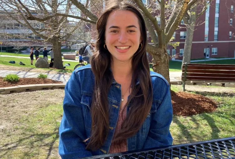 Beck Inglese sitting at table and smiling