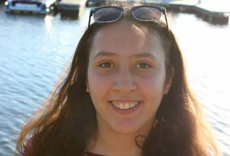 Oumaima Sriji stands in front of lake