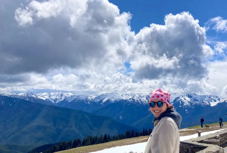 Anabelle Streckfus smiles at camera with mountain range in backbround