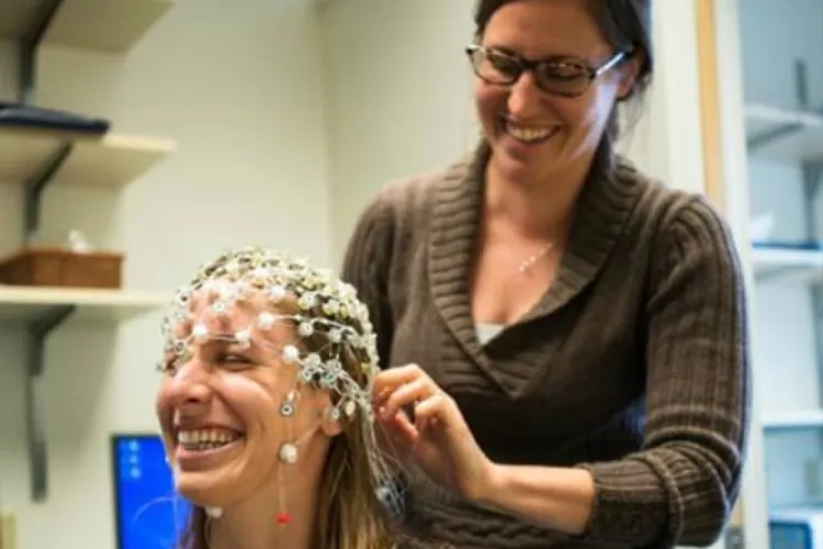 Emily Coderre records neural activity on subject using EEG equipment
