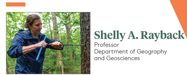 Shelly using an instrument on a tree trunk in a wet forest