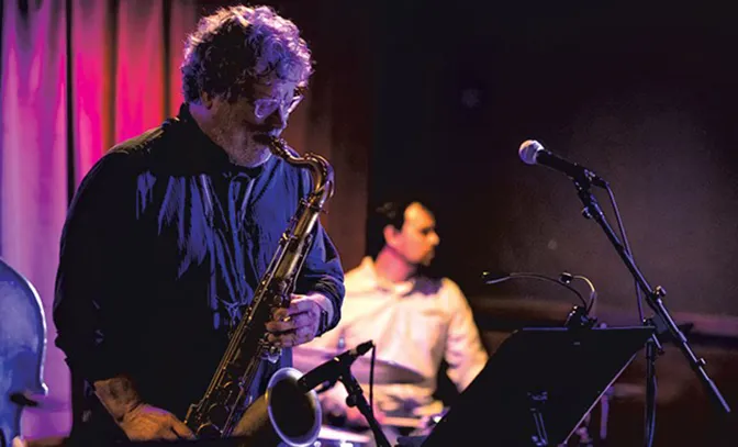 Alex Stewart on stage playing sax