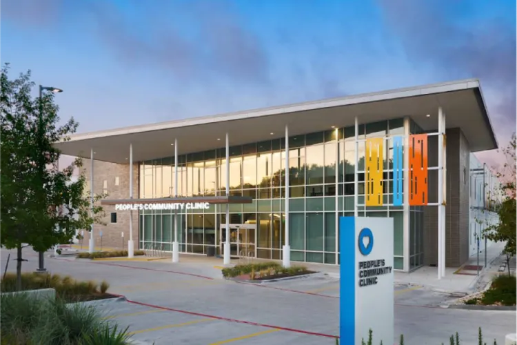 rectangular building with large windows and a sign that reads People's Community Clinic