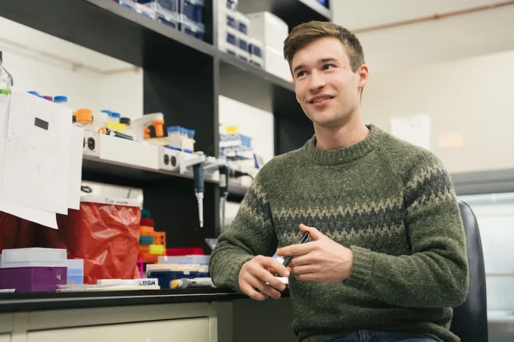 student sitting at a lab bench