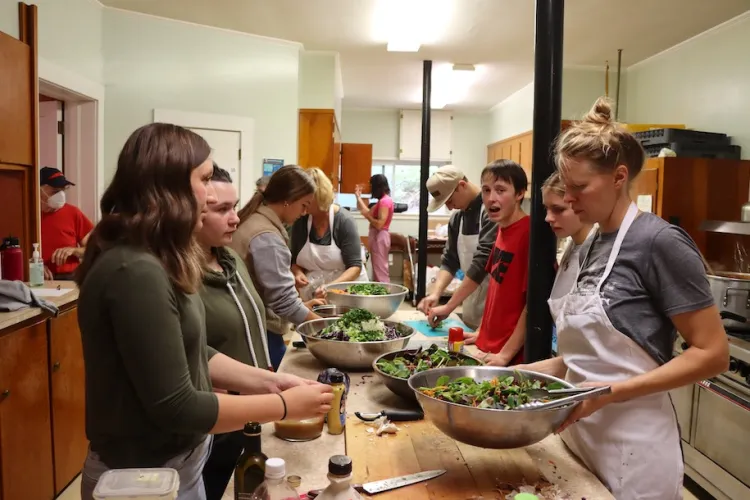 Reeve Basom, a community partner from the Center for an Agricultural Economy in Hardwick, working with students at the Hardwick Community Lunch.