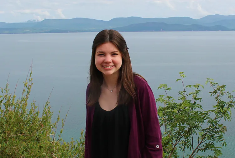 Elaina Sepede smiles with mountains in background