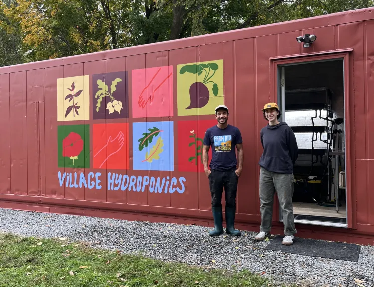 Jillian with executive director of Village Hydroponics, Nour El-Naboulsi, standing next to the hydroponic technology inside of a shipping container.