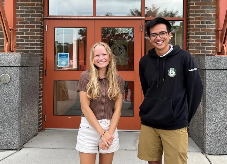Photo of students Benny and Lauren in front of the Aiken Center