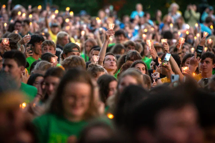 One candle stands out in a crowd of candles.