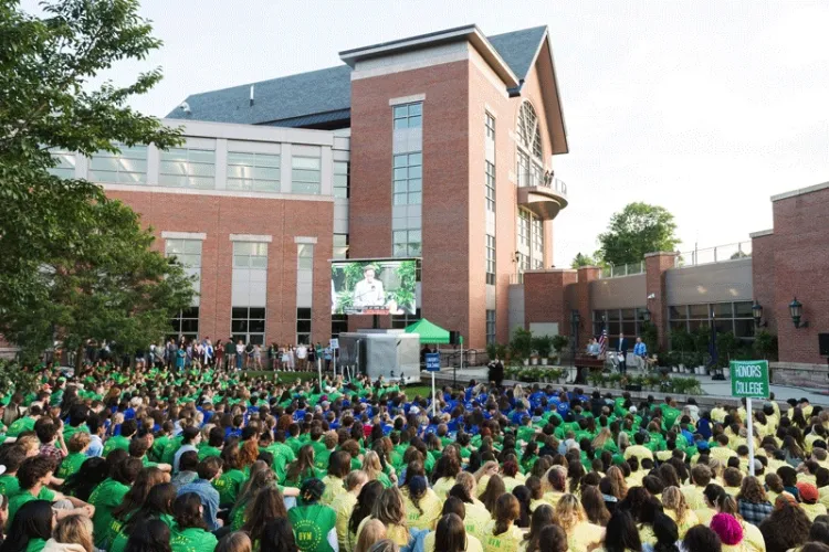 Thousands of students sit outside the Davis Center during Convocation