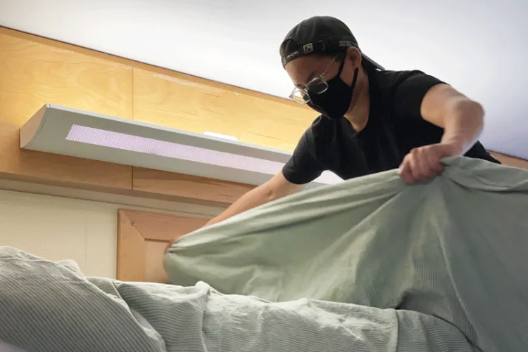 Ryder pulls sheets and bedding over a lofted mattress.